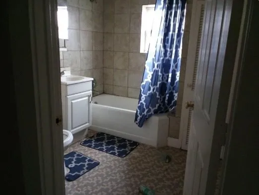 a bathroom with a toilet and shower