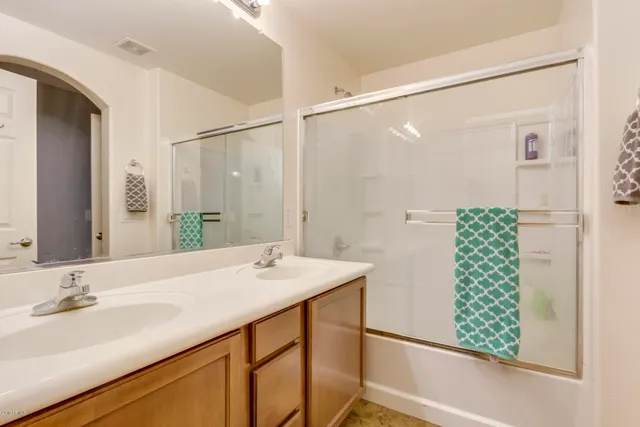 a bathroom with a double vanity sink and mirror