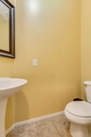 a white toilet sitting next to a sink