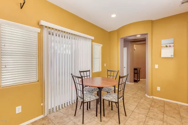 a view of a dining room with furniture and a window