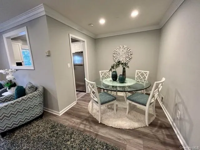 a dining room with furniture and wooden floor