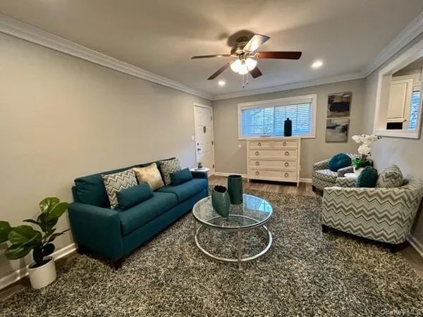 a living room with furniture and a chandelier