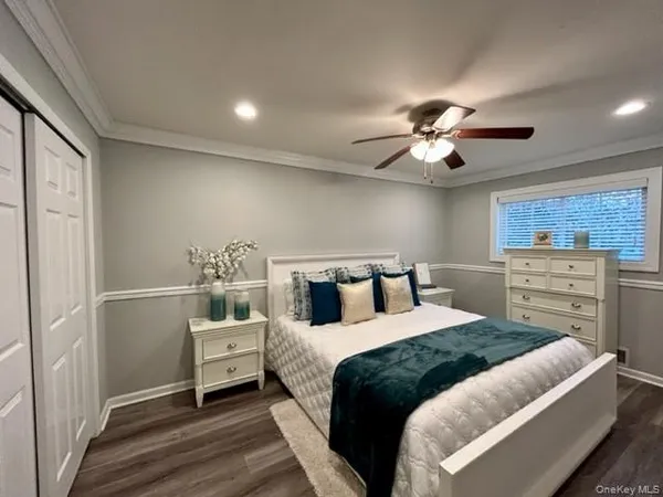 a bedroom with a bed and a ceiling fan