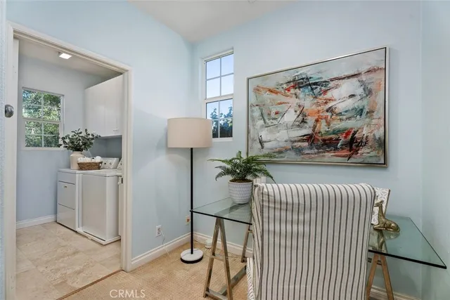 a living room with furniture and painting on the wall