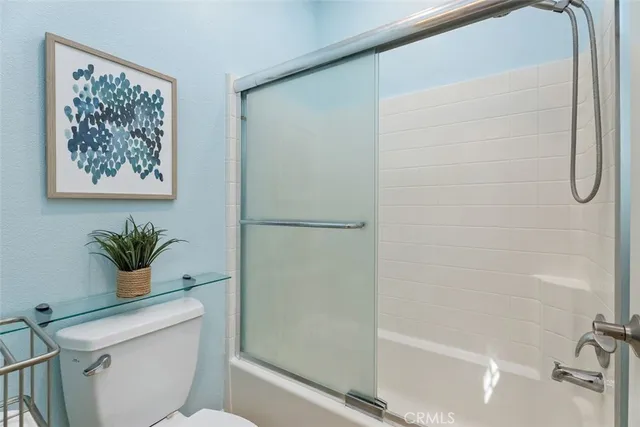 a bathroom with a shower and a toilet