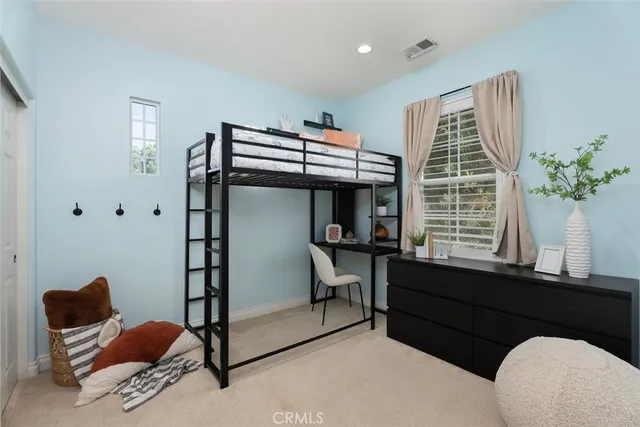 a bedroom with furniture and a window