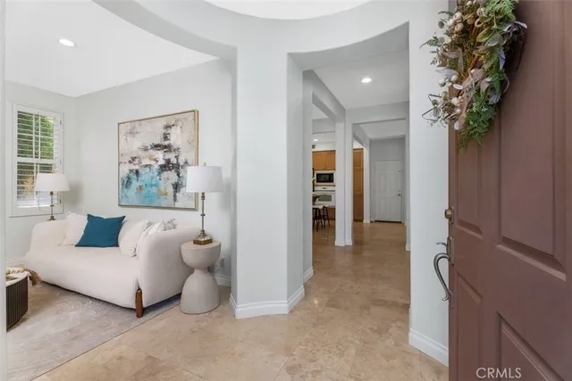 a living room with furniture and a potted plant