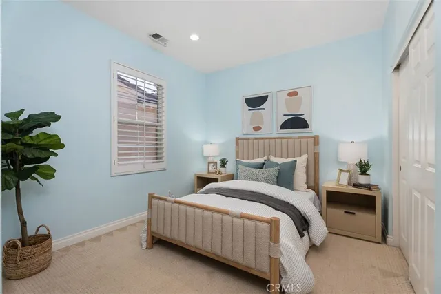 a bedroom with a bed and a window