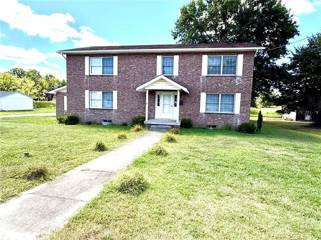 a front view of a house with a yard