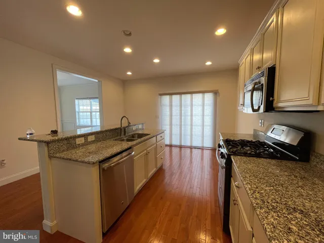a kitchen with sink stove and cabinets