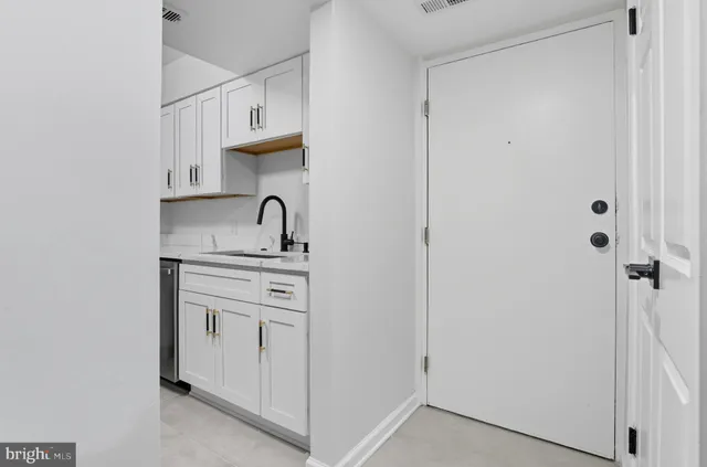 a kitchen with a refrigerator and a sink