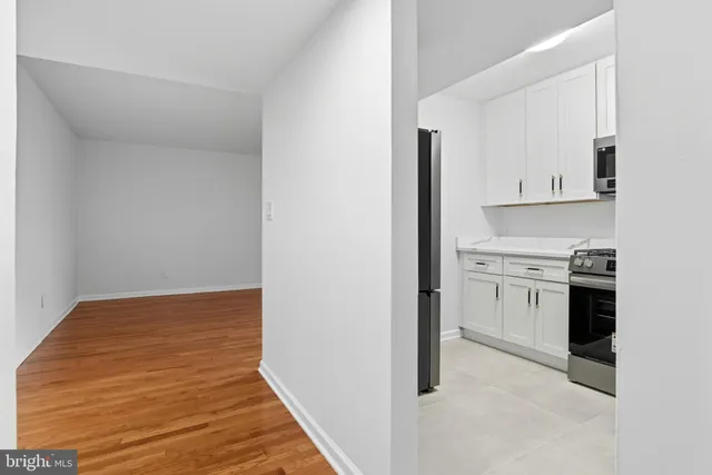 a view of a kitchen with a stove top oven