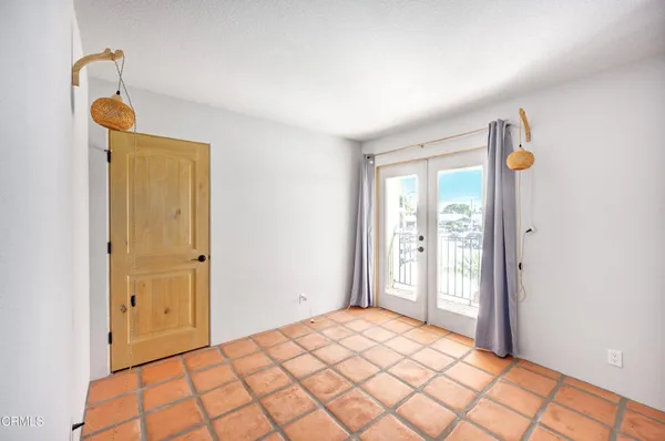 a bedroom with a bed and a mirror