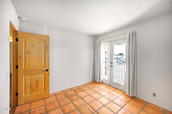 a bedroom with a bed and a door