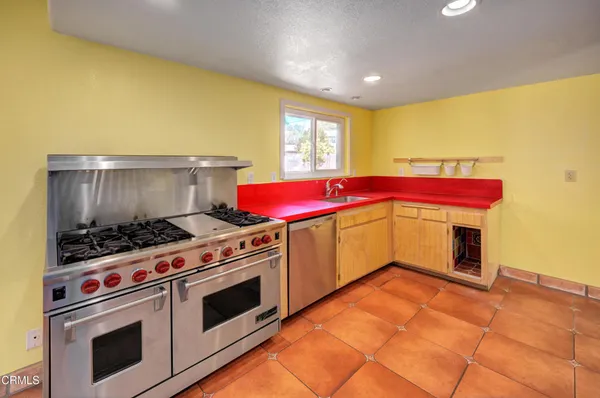 a kitchen with stainless steel appliances a stove and a refrigerator