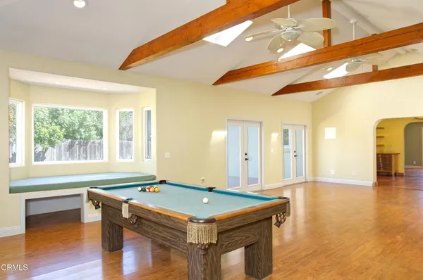 a room with pool table and window