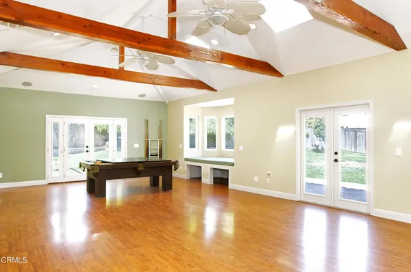 a view of a living room with kitchen island furniture and wooden floor