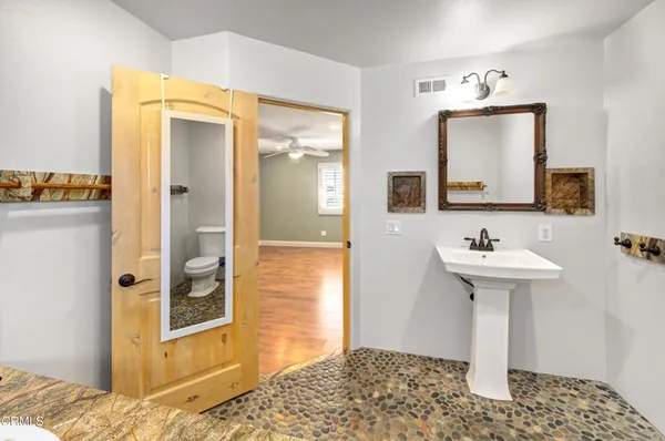a bathroom with a sink a mirror and a shower