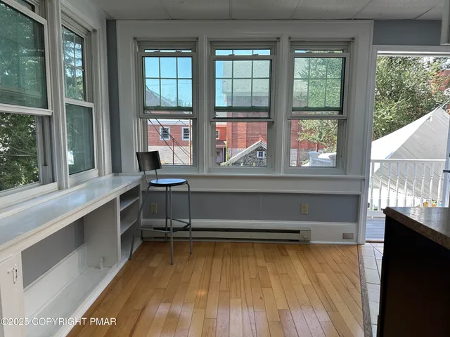 a view of wooden floor and a window