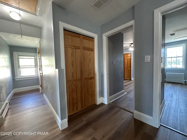 a view of a hallway with wooden floor