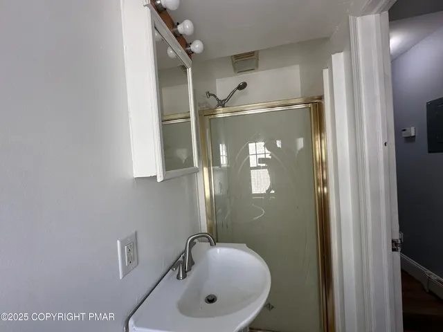 a bathroom with a sink and mirror