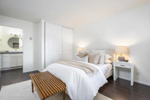 a bedroom with a bed and a night stand