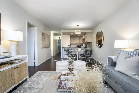 a living room with furniture and a wooden floor