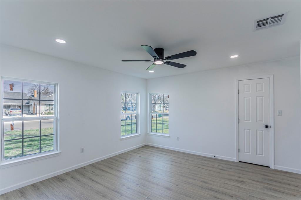 1026 La Clede Street Bellmead, TX 76705 - Photo 10 of 27 wooden floor in an empty room with a window