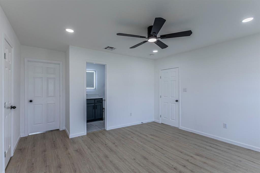 1026 La Clede Street Bellmead, TX 76705 - Photo 11 of 27 wooden floor in an empty room with a window