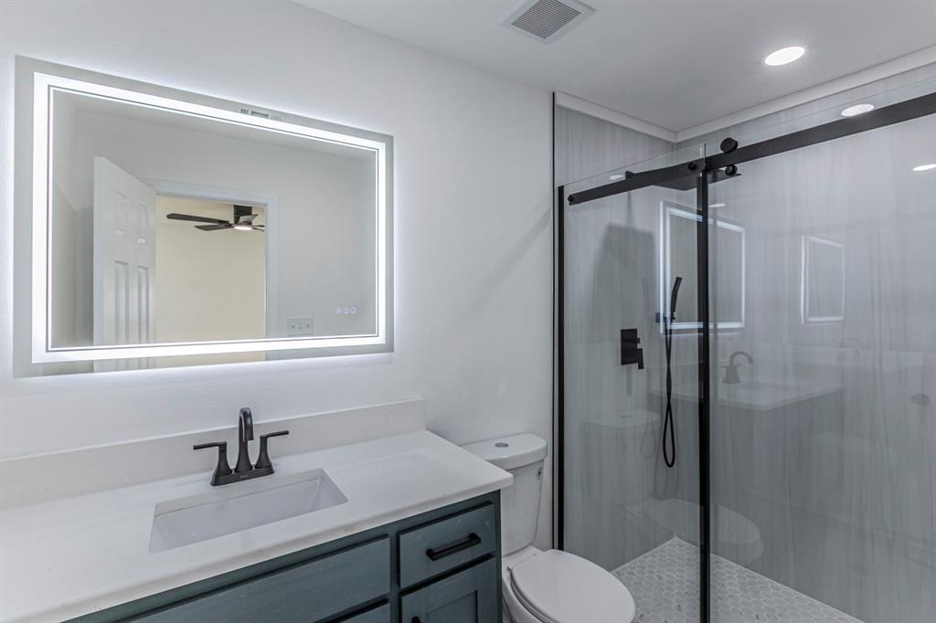 1026 La Clede Street Bellmead, TX 76705 - Photo 12 of 27 a bathroom with a sink a toilet and shower
