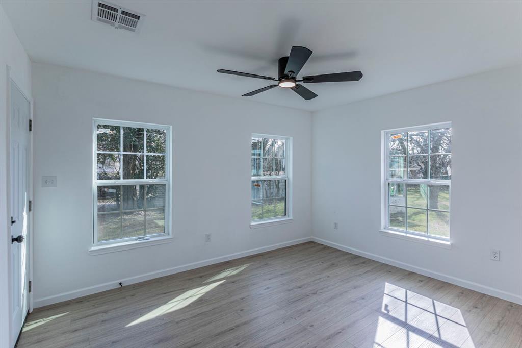 1026 La Clede Street Bellmead, TX 76705 - Photo 13 of 27 a view of an empty room with a window and wooden floor