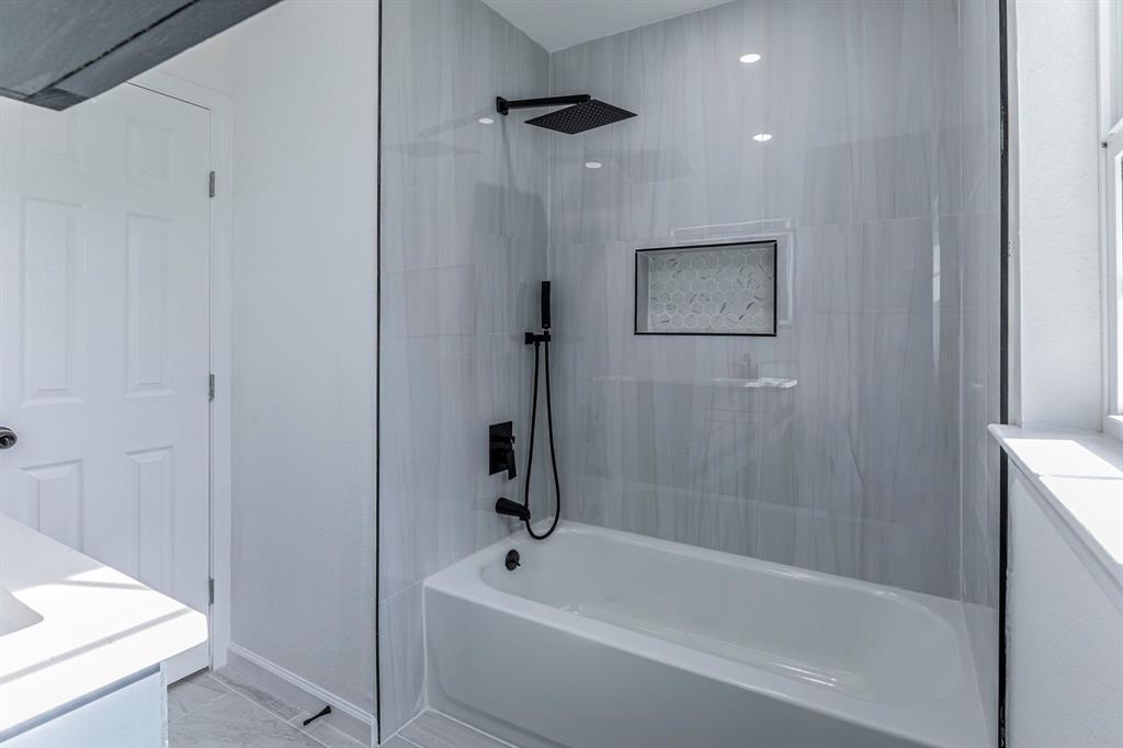 1026 La Clede Street Bellmead, TX 76705 - Photo 16 of 27 a bathroom with a bathtub and shower
