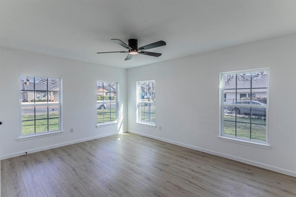 1026 La Clede Street Bellmead, TX 76705 - Photo 17 of 27 a view of an empty room with a window and wooden floor