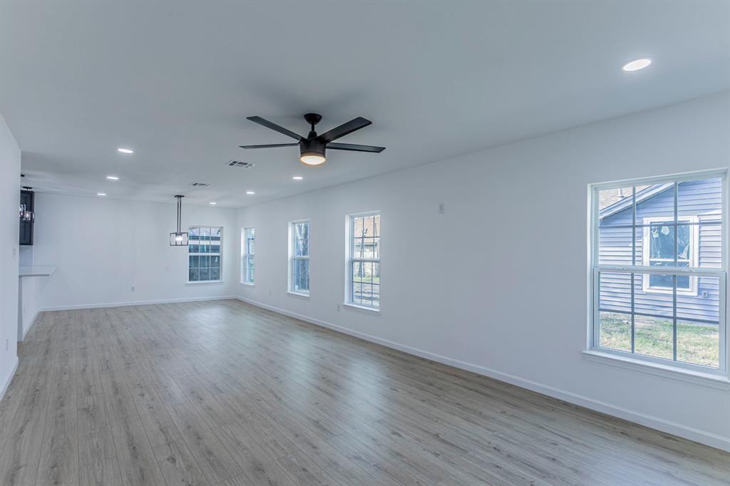 1026 La Clede Street Bellmead, TX 76705 - Photo 2 of 27 an empty room with wooden floor and windows