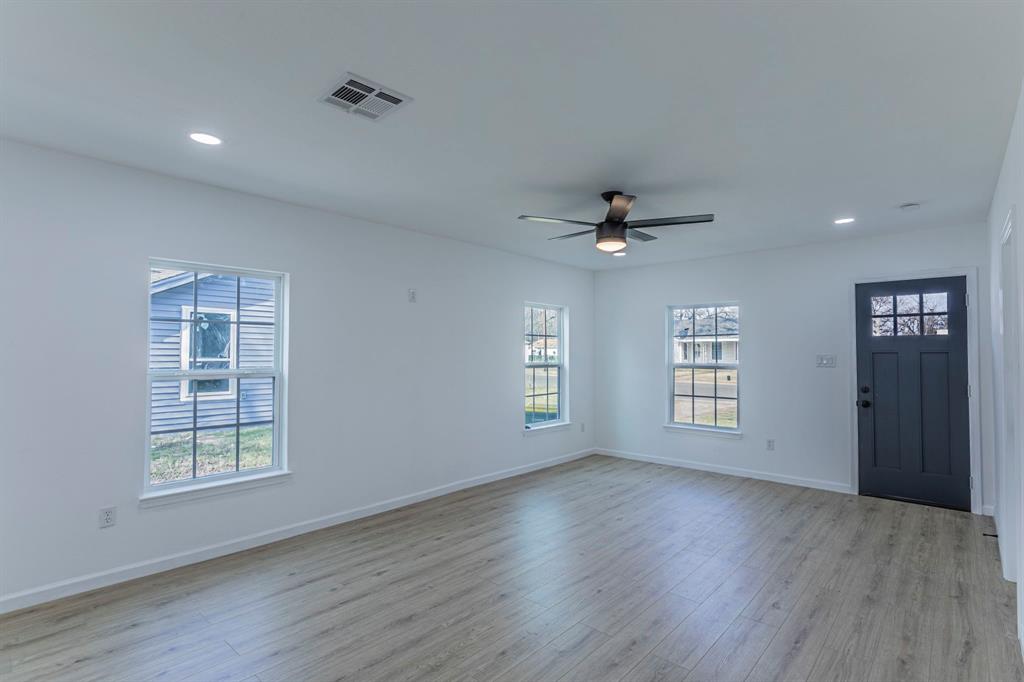 1026 La Clede Street Bellmead, TX 76705 - Photo 4 of 27 a view of an empty room with a window and wooden floor