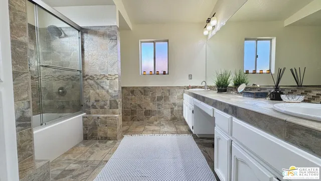 a bathroom with a bathtub and shower