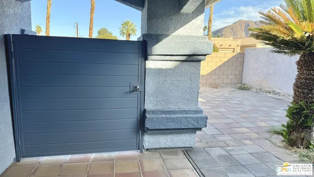 a living room with furniture a window and a potted plant