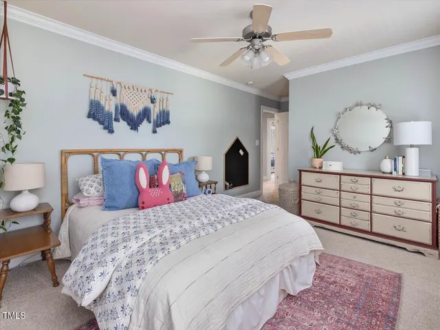 a living room with furniture and a baby crib