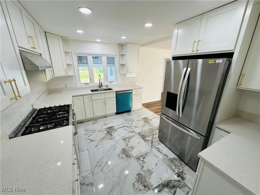 568 North Road Southeast Warren, OH 44484 - Photo 24 of 49 Kitchen with dishwasher, open shelves, stainless steel refrigerator with ice dispenser, under cabinet range hood, and tasteful backsplash