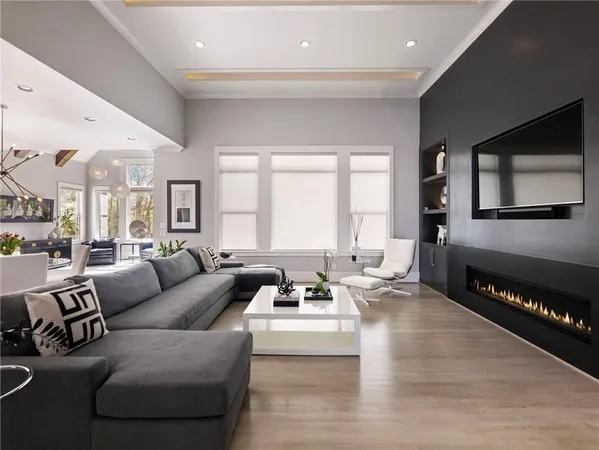 a living room with a bed furniture and a large window