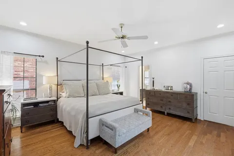 a room with a table chairs and ceiling fan