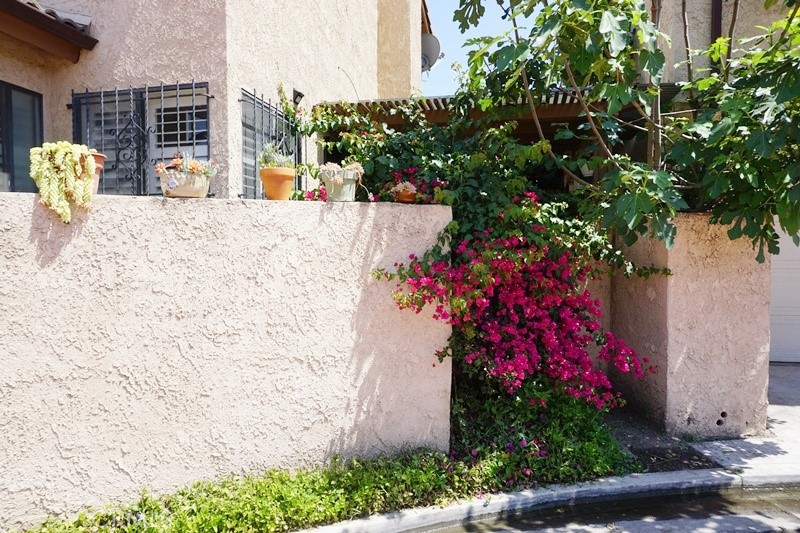 1604 Vía Rosa Baldwin Park, CA 91706 - Photo 20 of 27 a vase of flowers sitting on a table in front of a building