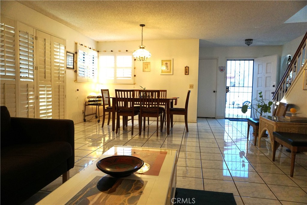 1604 Vía Rosa Baldwin Park, CA 91706 - Photo 3 of 27 a view of a dining room with furniture and a floor to ceiling window