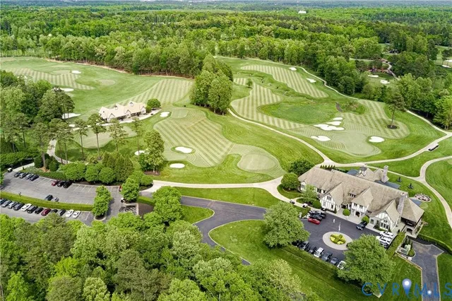 an aerial view of a residential houses with outdoor space and street view