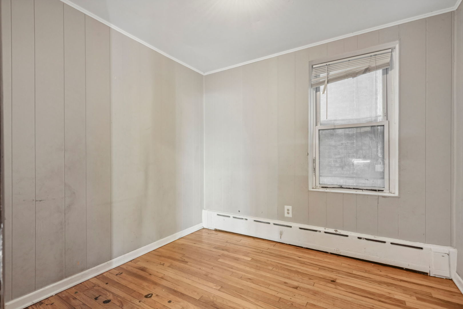 3140 West Pershing Road Chicago, IL 60632 - Photo 11 of 65 a view of an empty room with wooden floor and a window