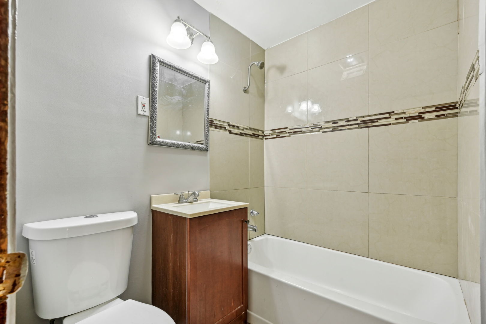 3140 West Pershing Road Chicago, IL 60632 - Photo 10 of 65 a bathroom with a sink a toilet a mirror and shower