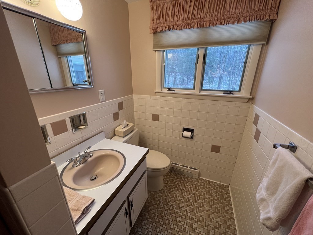 7 Johnson Road Sharon, MA 02067 - Photo 14 of 26 a bathroom with a sink a toilet and mirror