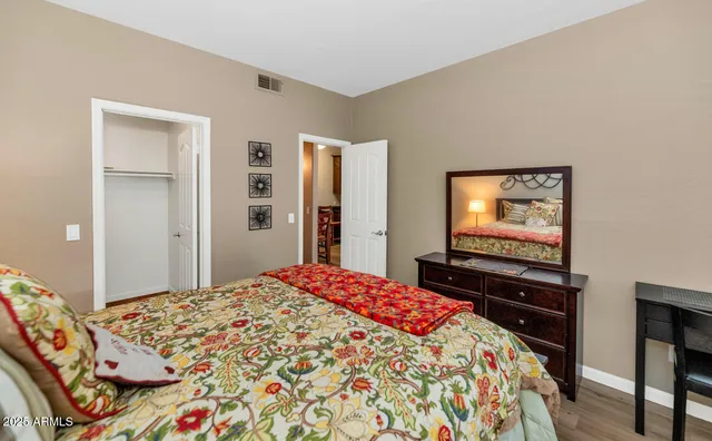 a bedroom with a bed and a flat screen tv