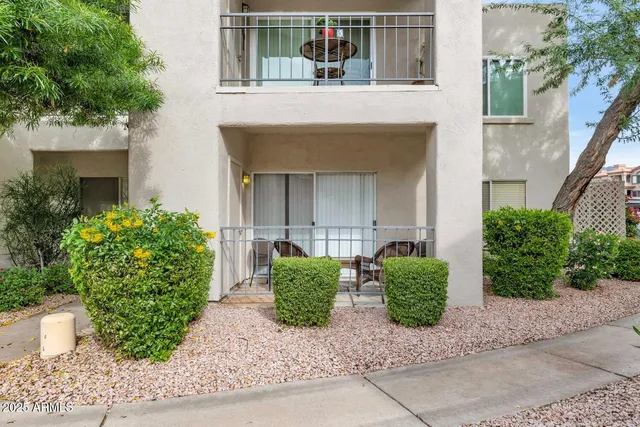 front view of a house with potted plants