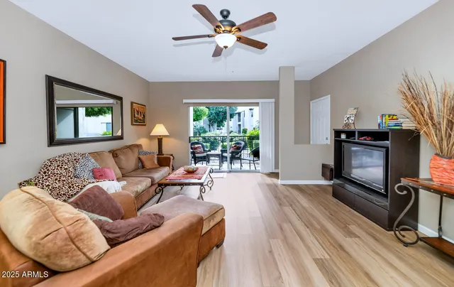 a living room with furniture a window and a fireplace
